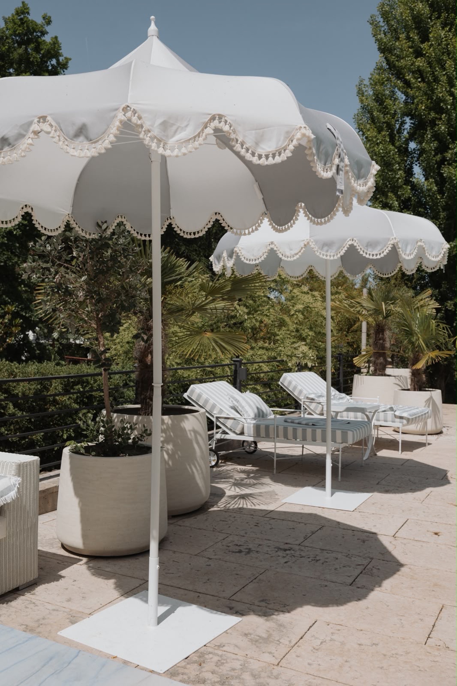 Scalloped parasols on a stone terrace